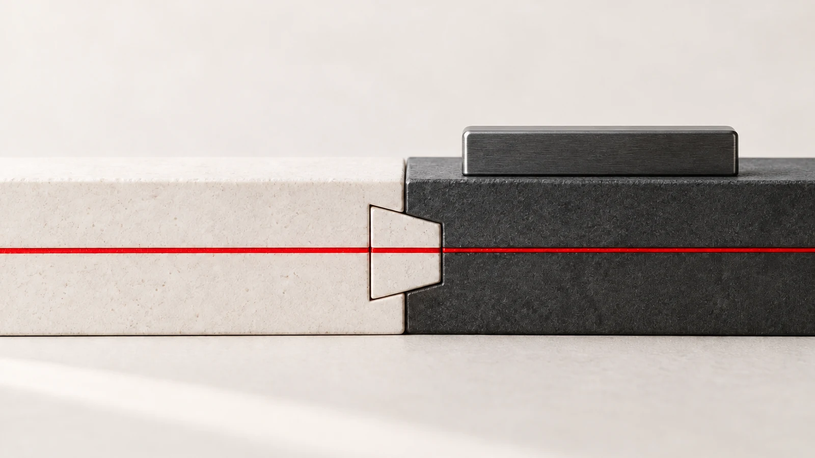 An off-white ceramic joint meets charcoal stone along an aligned red witness line, with an unmarked verification bridge on the receiving side.